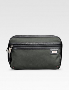 A soft, versatile travel essential design to sit on the counter or hang from a fixture in signature ballistic nylon. Zip closure Elastic loops for hanging Anti-bacterial lining Nylon with leather accents 9½W X 6½H X 4D Imported A soft, versatile travel essential design to sit on the counter or hang from a fixture in signature ballistic nylon. Zip closure Elastic loops for hanging Anti-bacterial lining Nylon with leather accents 9½W X 6½H X 4D Imported