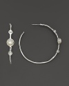 Three mother-of-pearl cabochons, set in sterling silver hoop earrings.