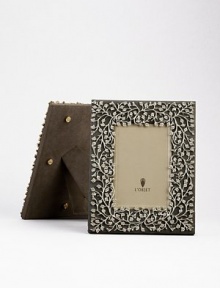 A charming platinum floral motif is laid over a suede background, creating an eye-catching, completely handmade frame fit for any treasured photograph. From the Lorel Collection Accommodates a 4 X 6 photograph Overall, 7¼ X 9 Imported 