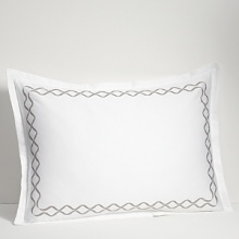 For lovers of fine bed dressing, Ogee Embroidery emulates understated opulence. A sophisticated, contemporary approach to a classic ogee design. Satin stitch and twill texture embroidery create a sleek vertical line. The sham is framed with gently looping corners.