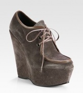 Smooth leather trim lines this lace-up suede design, elevated by a tall platform wedge. Self-covered wedge, 5¾ (145mm)Covered platform, 2 (50mm)Compares to a 3¾ heel (95mm)Suede upper with leather trimLeather liningRubber solePadded insoleImported