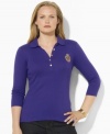 Sleek gold-toned buttons and a metallic embroidered crest lend regal elegance to Lauren Ralph Lauren's soft cotton  plus size polo shirt.