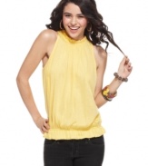 A high, ruffled neckline and flattering blouson fit make this top from Planet Gold a delightful match to your skinny jeans!