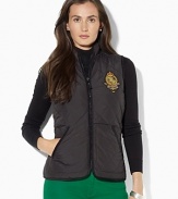 A lightweight vest in diamond-quilted microfiber is an essential layering piece for the season, finished with an embroidered crest for heritage charm.
