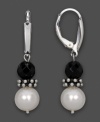 Opposites attract. Faceted black onyx (6 mm) and sleek cultured freshwater pearl (7-8 mm) come together exquisitely in these drops. Earrings crafted in sterling silver. Approximate drop: 1-1/2 inches.