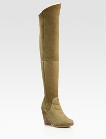 Thigh-high suede wedge design with an exposed back zipper and contoured shaft. Stacked wedge, 4 (100mm)Covered platform, ½(15mm)Compares to a 3½ heel (90mm)Shaft, 24Leg circumference, 15Suede upperBack zipperShearling liningRubber solePadded insoleMade in Italy