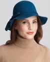 A wool floppy hat with a small brim and tassel trim for a classic look.