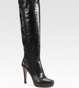 Tall leather silhouette with a hidden platform. Self-covered heel, 4¼ (110mm)Hidden platform, ¾ (20mm)Compares to a 3½ heel (90mm)Shaft, 17Leg circumference, 4½Leather upperSide zipLeather lining and solePadded insoleMade in Italy