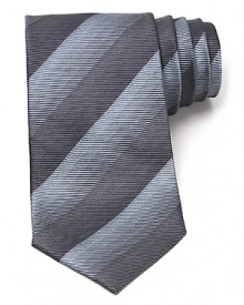 Thin tonal stripes dash across this handsome tie, rendered in luxurious Italian silk for classic opulence.