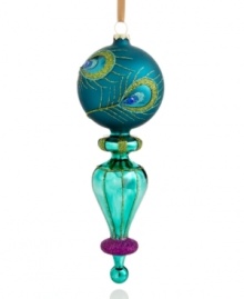 In a delicate finial shape crafted of glass, this lovely ornament swirls and shines upon your tree with a peacock feather motif. Purple glitter at the bottom gives it an extra allure. In a delicate finial shape crafted of glass, this lovely ornament swirls and shines upon your tree with a peacock feather motif. Purple glitter at the bottom gives it an extra allure.