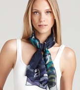 A long silk scarf with a whimsical print of floating gancinis and ombré animal print.