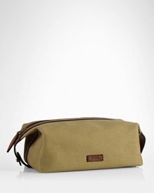An impeccably stylish carrying case for the modern gentleman, this lightweight pouch provides sharp transport for essential toiletries in a leather-trimmed canvas construction. An impeccably stylish carrying case for the modern gentleman, this lightweight pouch provides sharp transport for essential toiletries in a leather-trimmed canvas construction.