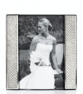 Display a wedding photo with the glitz and glam it deserves in this silver-plated picture frame from Leeber. Clear crystals add extravagant shine to happy memories.