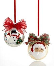 Treasure the hand-painted charm of Kurt Adler's Sarabella ball ornaments. A festive winter scene topped with a shimmering red bow and Santa's face shining on matte gold glass bring something special to your tree. Treasure the hand-painted charm of Kurt Adler's Sarabella ball ornaments. A festive winter scene topped with a shimmering red bow and Santa's face shining on matte gold glass bring something special to your tree.
