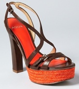 A captivating orange platform infuses instant color into a pair of strappy sandals from Aqua.