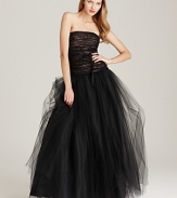 An extravagant skirt of gauzy tulle is crowned with an intricately ruched bodice on this ML Monique Lhuillier strapless gown. A wispy ribbon at the waist completes this stunning evening look.