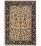 Inspired by the easily recognizable and intricately beautiful textiles of the Kirman region of ancient Persia, this Indo-Kirman rug features graceful floral designs in a rich palette of individually-dyed colors including indigo, soft blues, peach-corals, golds, lavender, and a multitude of soft greens. Patterned on an antique carpet woven circa 1910, it has a soft luster-wash that imparts a soft vintage finish.