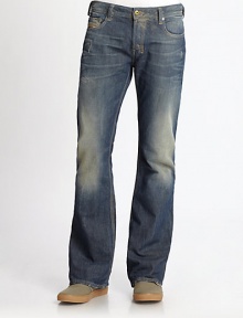 A rugged denim design with distressed elements, finished in a resin and golden spray. Banded waist with belt loopsFront zip and button closureFive-pocket styleFaded, whiskered and frayed detailsSignature stitching on back pockets Back patch detail Bootcut silhouetteInseam, about 34 Cotton Machine wash Imported