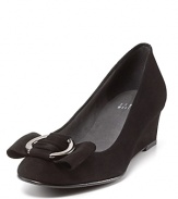Demure demi-wedge pumps flaunt silver buckle bows, evoking a sense of ladylike chic. By Stuart Weitzman.