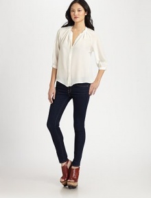 Exude sophistication in this pure silk crewneck with a hidden button front and three-quarter bishop sleeves. CrewneckHidden button frontThree-quarter bishop sleevesButtoned cuffsSilkDry cleanImportedModel shown is 5'10 (177cm) wearing US size Small.