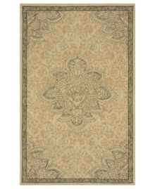 This soft, sophisticated piece lends earthy tones to any patio, veranda or indoor space. Featuring a beautiful center medallion on light tan ground, this durable area rug is hand-hooked of strong, polypropylene fibers.