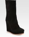Classic seasonal staple rendered in lush suede with a heightening wedge. Self-covered wedge, 4¾ (120mm)Covered platform, 1 (25mm)Compares to a 3¾ heel (95mm)Shaft, 9½Leg circumference, 12½Suede upperPull-on styleLeather liningRubber solePadded insoleMade in ItalyOUR FIT MODEL RECOMMENDS ordering one half size up as this style runs small. 