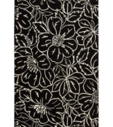 Striking ivory outlines render a high-style floral motif that pops against a jet-black ground. This Nourison rug is hand-tufted from premium-quality wool and meticulously hand-carved for a lush dimensional effect, every detail coming together to create a bold focal point in any setting.