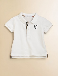 A classic polo in breezy pique with Burberry check accents.Ribbed polo collarShort sleeves with ribbed cuffsButton placket with check inside trimEmbroidered logo on chestSide slit hem with longer-in-back tennis tailsCottonMachine washImported Please note: Number of buttons may vary depending on size ordered. A classic polo in breezy pique with Burberry check accents.Ribbed polo collarShort sleeves with ribbed cuffsButton placket with check inside trimEmbroidered logo on chestSide slit hem with longer-in-back tennis tailsCottonMachine washImported Please note: Number of buttons may vary depending on size ordered.