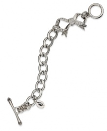 Juicy Couture's darling toggle bracelet shines with pave stones and adorable bow charms. Chain crafted in stainless steel. Charms and closure crafted in silver tone brass. Approximate length: 7-1/2 inches. Approximate drop: 1-1/2 inches. Juicy Couture's darling toggle bracelet shines with pave stones and adorable bow charms. Chain crafted in stainless steel. Charms and closure crafted in silver tone brass. Approximate length: 7-1/2 inches. Approximate drop: 1-1/2 inches.