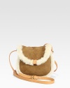 Rich sheepskin and shearling make a chic pairing in this demure crossbody design.Leather adjustable shoulder strap, 18-22 drop Magnetic top closure Shearling lining 7W X 6H X 3D Imported