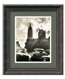 Sunlight streams through a cloudy sky to illuminate 42nd Street and the iconic Empire State Building in this classic black-and-white photo print of New York City by Mario de Biasi. Fluted detail gives the black wood frame an air of distinction. Sunlight streams through a cloudy sky to illuminate 42nd Street and the iconic Empire State Building in this classic black-and-white photo print of New York City by Mario de Biasi. Fluted detail gives the black wood frame an air of distinction.