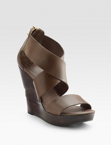 Dramatic width and height gives this crisscross leather sandal stand-out effect. Sculpted wooden wedge, 4½ (115mm) Platform, 1½ (40mm) Compares to a 3 heel (75mm) Back zip closure Leather lining Padded insole Rubber sole ImportedOUR FIT MODEL RECOMMENDS ordering true size.. 