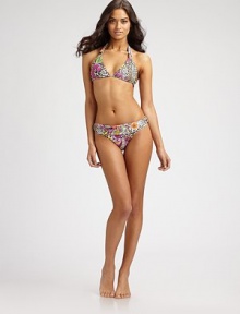 Add some edge to your swim style with this super-sexy halter bikini top in a fierce animal print. Triangle cupsHalter straps with adjustable gold embellishmentsBack tie closuresFully lined82% polyamide/18% spandexHand washImported Please note: Bikini bottom sold separately.