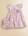A charmingly traditional dress in crisp cotton features a dogwood floral pattern for a sweet summer look.RoundneckShort flutter sleevesBack buttonsGathered empire waist with flower detailFull skirt with ruffled petticoatCottonMachine washImported Please note: Number of buttons may vary depending on size ordered. 