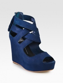 Daringly modern, this high-wedge suede design is structured with crisscross straps around the ankle.Self-covered wedge heel, 4 (100mm) Self-covered platform, 1¼ (30mm) Compares to a 2¾ heel (70mm) Open toe Back zipper with tassel Leather lining and sole Padded insole ImportedOUR FIT MODEL RECOMMENDS ordering one half size up as this style runs small. 
