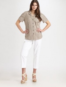 A classic gingham modernized in a stretch cotton blend with delightful ruching at the sleeves.Point collarButton placketShort cuffed sleeves with ruchingDarts at waist for a little shapingAbout 27½ from shoulder to hem74% cotton/24% nylon/2% spandexMachine washImported