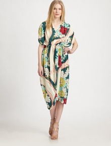 A colorful graphic print swirls around smooth fabric, with dramatically draped skirt for a fluid-effect. V-neckGathered shouldersOver-sized short dolman sleevesSelf-tie waistAsymmetrical hemAbout 49 from natural waistPolyesterDry cleanMade in USA of Italian fabricModel shown is 5'10 (177cm) wearing US size Small.