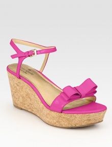 Secured by a dainty, adjustable ankle strap, this natural cork wedge features smooth patent leather straps and a bow adornment. Cork wedge, 3 (75mm)Cork platform, 1 (25mm)Compares to a 2 heel (50mm)Patent leather upperLeather liningRubber solePadded insoleImportedOUR FIT MODEL RECOMMENDS ordering one half size down as this style runs large. 