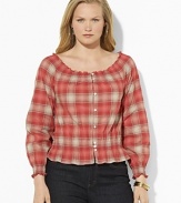 A soft woven cotton top channels western inspiration with a faded plaid pattern and smocked detailing.