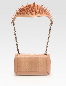 A dramatic style in luxurious python with patent leather trim and a spiked shoulder detail.Chain and embellished patent leather shoulder strap, 10½ dropMagnetic snap flap closureThree inner compartmentsSignature red lining7W X 4H X 1½DMade in Italy