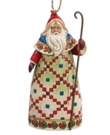 Inspired by traditional tales of St. Nicholas, Jim Shore's Santa figurine wears a beautiful, hand-painted Scandinavian robe and carries a slender staff to symbolize his good-hearted nature. Display standing or hang as an ornament. Inspired by traditional tales of St. Nicholas, Jim Shore's Santa figurine wears a beautiful, hand-painted Scandinavian robe and carries a slender staff to symbolize his good-hearted nature. Display standing or hang as an ornament.