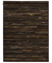 Western chic. Invite sumptuous style into your home with the one-of-a-kind Prairie rug from Calvin Klein. Tonal bars of rich cowhide are hand-tufted in an alternating pattern to create a stunning, mosaic-like appearance and a divinely textured feel. Western chic. Invite sumptuous style into your home with the one-of-a-kind Prairie rug from Calvin Klein. Tonal bars of rich cowhide are hand-tufted in an alternating pattern to create a stunning, mosaic-like appearance and a divinely textured feel.
