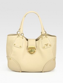 Pebbled calfskin with a shapely design and distinct push-lock detail.Double top handles, 8 drop Push-lock closure Protective metal feet One inside zip pocket Signature jacquard lining 14W X 11H X 6D Made in Italy