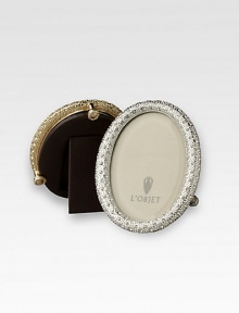 A keepsake accent for life's favorite moments and people, upholstered in smooth leather with gold- or platinum-plating and glimmering Swarovski crystals. Accommodates a 2 X 3 round photograph Hand wipe Imported A keepsake accent for life's favorite moments and people, upholstered in smooth leather with gold- or platinum-plating and glimmering Swarovski crystals. Accommodates a 2 X 3 round photograph Hand wipe Imported