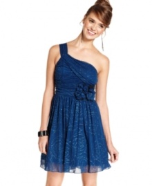 Sparkle like no other in this a-line dress from BCX! Flaunts a chic, one-shoulder style and the prettiest glitter design. Sparkle like no other in this a-line dress from BCX! Flaunts a chic, one-shoulder style and the prettiest glitter design.