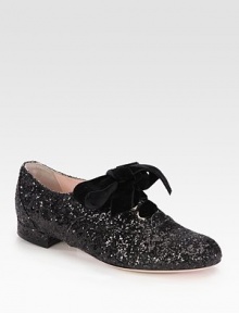 An oversized velvet bow adorns this glittery on-the-go essential. Glitter-coated fabric upperLeather lining and solePadded insoleMade in Italy