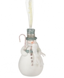 Crafted of pure porcelain bisque, bring some winter cheer to your tree this season with the snowman ornament from Department 56. Features a blue and silver top hat, white knit scarf and festive candy cane accessory. Crafted of pure porcelain bisque, bring some winter cheer to your tree this season with the snowman ornament from Department 56. Features a blue and silver top hat, white knit scarf and festive candy cane accessory.