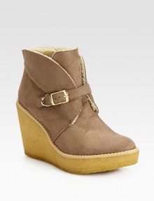 Casual faux suede essential with an adjustable buckle strap, mock shearling lining and elevated rubber wedge. Rubber heel, 3¾ (95mm)Rubber platform, 1¼ (30mm)Compares to a 2½ heel (65mm)Faux suede upperAdjustable buckle strapFaux shearling liningRubber solePadded insoleImported