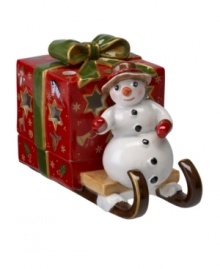 A snowman carries a brilliant surprise on the back of his sleigh in this beautifully crafted candle holder from Villeroy & Boch. Light shines through pierced stars in a present wrapped in charming vintage style. A snowman carries a brilliant surprise on the back of his sleigh in this beautifully crafted candle holder from Villeroy & Boch. Light shines through pierced stars in a present wrapped in charming vintage style.