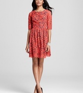 A contrast-colored lining peeks out through bright red lace on this season-less Shoshanna dress.